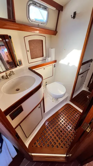 La Vie Dansante Yacht Photos Pics 1998 Little Harbor WhisperJet 55 yacht bathroom with wooden accents and compact design.