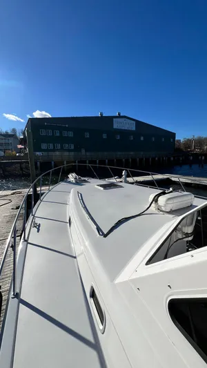 La Vie Dansante Yacht Photos Pics 1998 Little Harbor WhisperJet 55 yacht docked at a marina under clear blue skies.