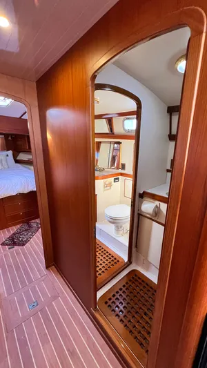 La Vie Dansante Yacht Photos Pics Interior of 1998 Little Harbor WhisperJet 55 yacht, featuring a wooden bathroom and bedroom.