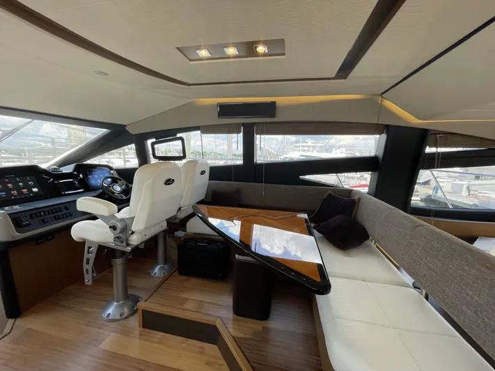 Kings' Ransom Yacht Photos Pics Luxurious interior of 2017 Sea Ray L590 Fly yacht with helm and seating area.