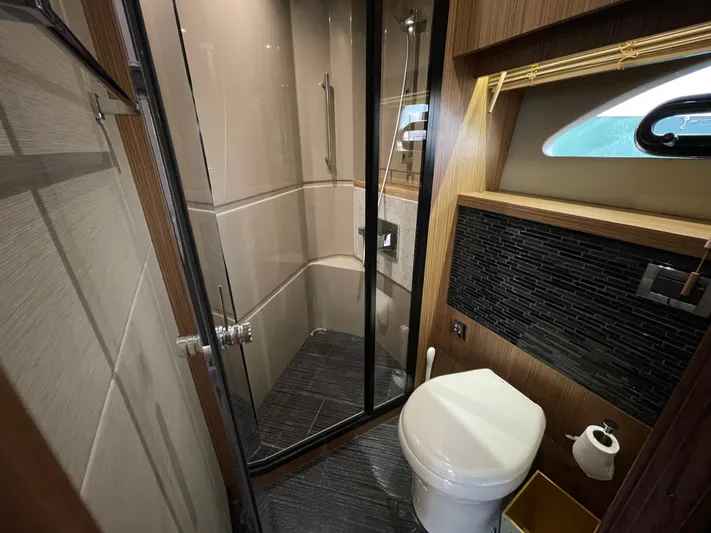 Kings' Ransom Yacht Photos Pics Luxurious bathroom in 2017 Sea Ray L590 Fly yacht with modern shower and toilet.