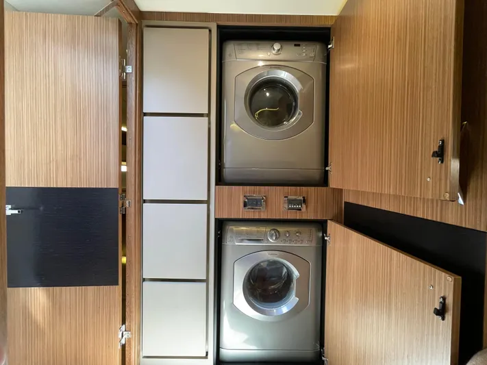 Kings' Ransom Yacht Photos Pics Laundry area with washer and dryer in 2017 Sea Ray L590 Fly yacht.