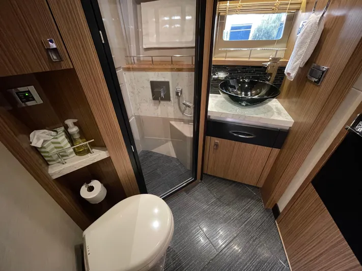 Kings' Ransom Yacht Photos Pics Luxurious bathroom in 2017 Sea Ray L590 Fly yacht with modern fixtures and elegant design.