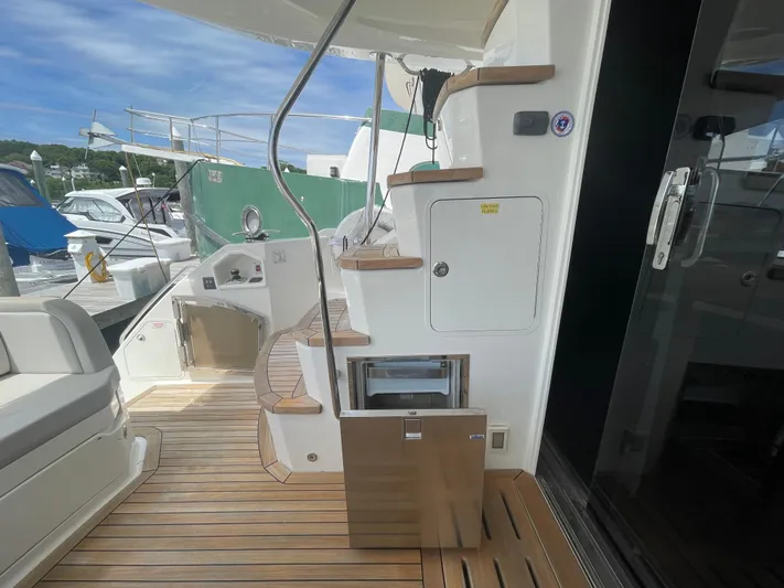 Kings' Ransom Yacht Photos Pics 2017 Sea Ray L590 Fly yacht deck with wooden flooring and staircase.