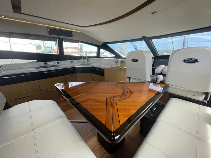 Kings' Ransom Yacht Photos Pics Luxurious interior of 2017 Sea Ray L590 Fly yacht with elegant seating and modern kitchen.