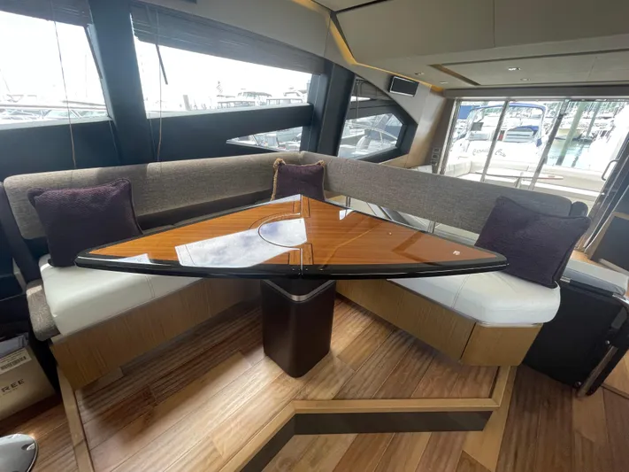 Kings' Ransom Yacht Photos Pics Luxurious interior of 2017 Sea Ray L590 Fly yacht with elegant seating and wooden table.