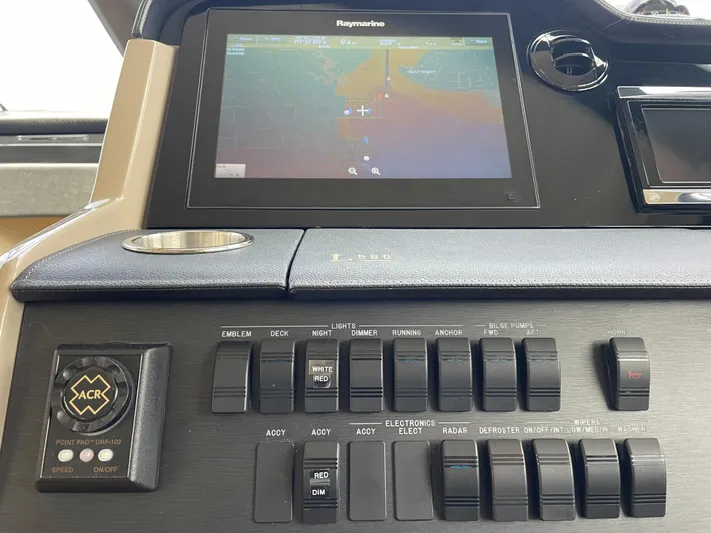 Kings' Ransom Yacht Photos Pics Control panel of 2017 Sea Ray L590 Fly yacht with navigation display and switches.