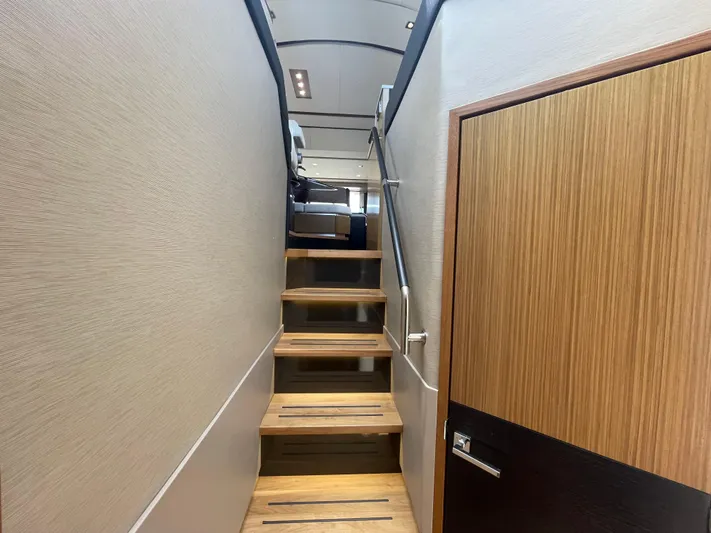 Kings' Ransom Yacht Photos Pics Staircase inside 2017 Sea Ray L590 Fly yacht, featuring modern wood and metal design.