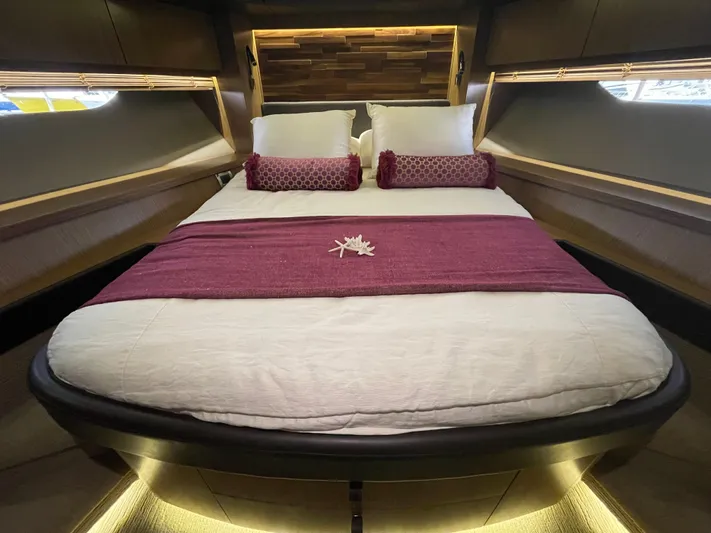Kings' Ransom Yacht Photos Pics Luxurious bedroom interior of 2017 Sea Ray L590 Fly yacht with elegant bedding and ambient lighting.