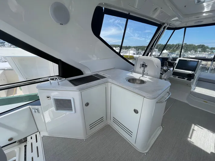 Kings' Ransom Yacht Photos Pics 2017 Sea Ray L590 Fly yacht interior with sleek kitchenette and modern helm station.