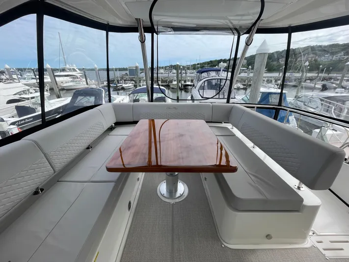 Kings' Ransom Yacht Photos Pics Luxurious 2017 Sea Ray L590 Fly yacht interior with elegant seating and wooden table.