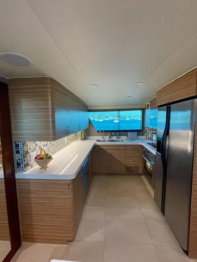 Fnfun Yacht Photos Pics Modern kitchen interior on a 1989 Hatteras CPMY yacht with sleek wood cabinetry.