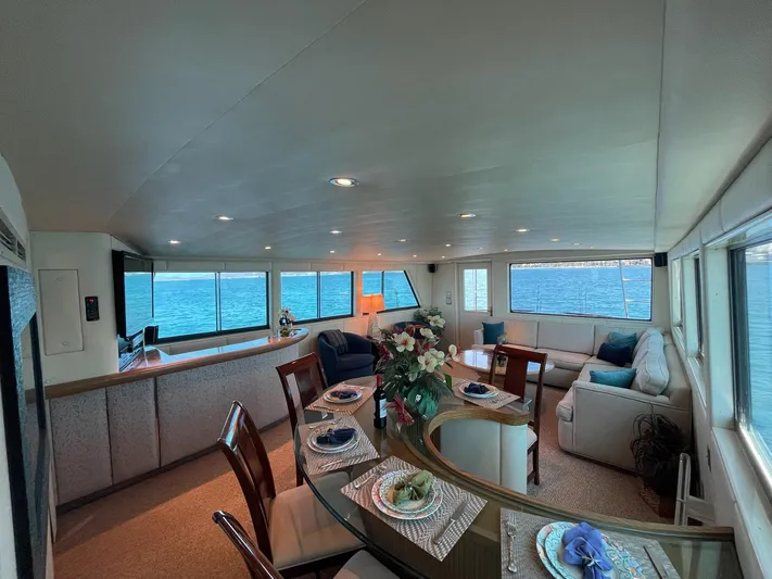 Fnfun Yacht Photos Pics Luxurious 1989 Hatteras CPMY yacht interior with elegant dining and seating area, ocean view.