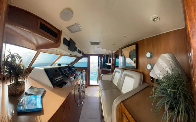 Fnfun Yacht Photos Pics 1989 Hatteras CPMY yacht interior with helm, seating, and ocean view through windows.