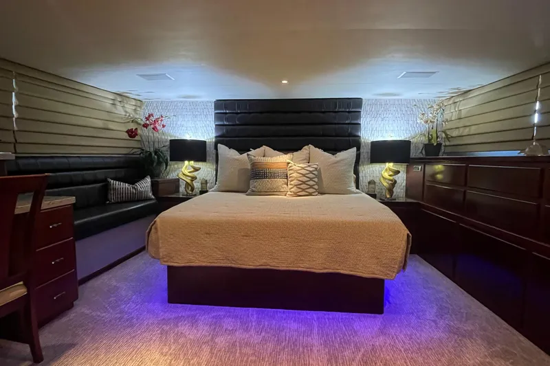 Fnfun Yacht Photos Pics Luxurious bedroom interior of 1989 Hatteras CPMY yacht with ambient lighting and elegant decor.