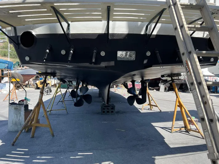 Fnfun Yacht Photos Pics 1989 Hatteras CPMY yacht on dry dock, showing propellers and hull maintenance.
