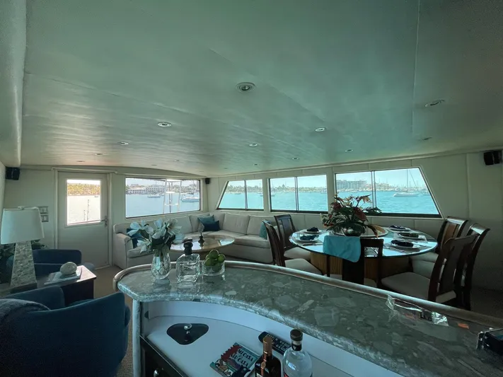 Fnfun Yacht Photos Pics Luxurious 1989 Hatteras CPMY yacht interior with elegant dining area and panoramic windows.