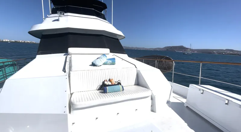 Fnfun Yacht Photos Pics 1989 Hatteras CPMY yacht deck with seating, ocean view, and clear blue sky.