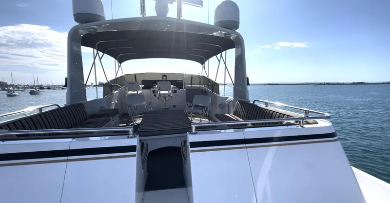 Fnfun Yacht Photos Pics 1989 Hatteras CPMY yacht deck with seating, under sunny skies on calm water.