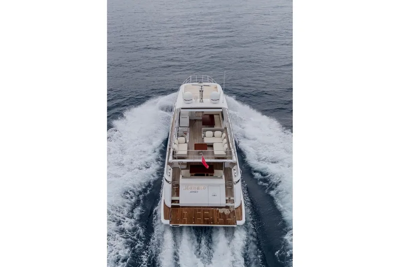 Mahalo Yacht Photos Pics Aerial view of 2019 Azimut 66 yacht cruising on open water.