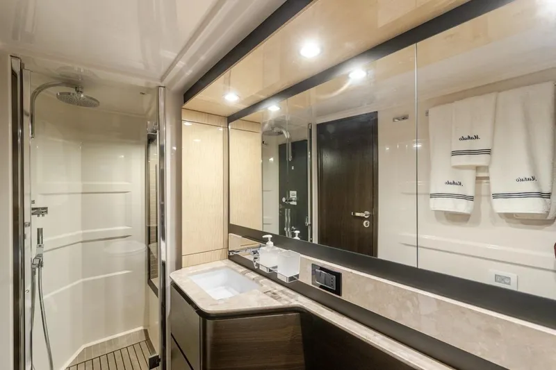 Mahalo Yacht Photos Pics Luxurious bathroom in 2019 Azimut 66 yacht with modern fixtures and elegant design.