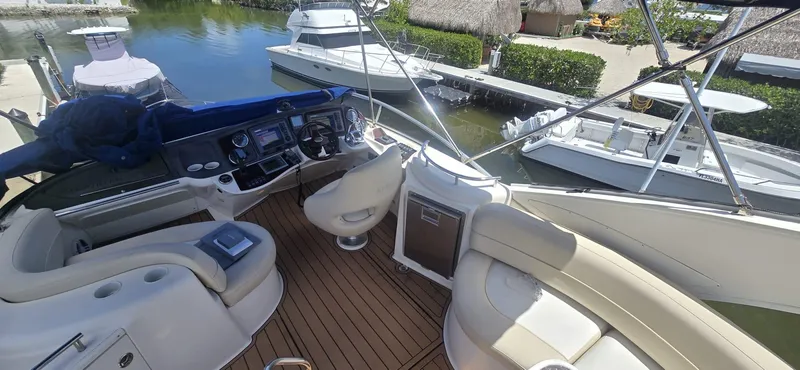  Yacht Photos Pics 2012 Meridian 341 Sedan yacht interior with helm, seating, and docked boats in marina.