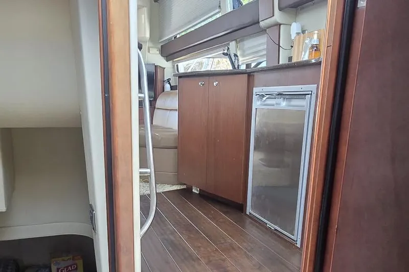  Yacht Photos Pics Interior of 2012 Meridian 341 Sedan yacht with wood cabinetry and seating.