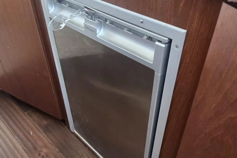  Yacht Photos Pics Built-in refrigerator on 2012 Meridian 341 Sedan yacht, with wooden cabinetry and stainless steel finish.