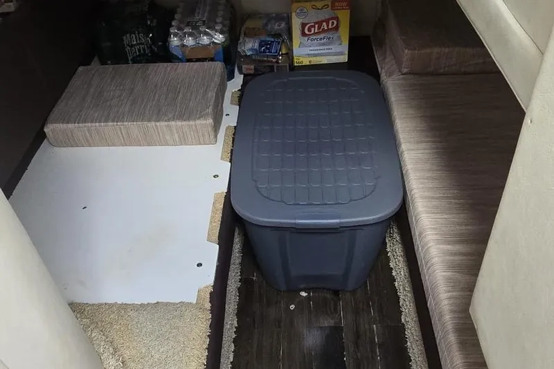  Yacht Photos Pics Interior storage area of a 2012 Meridian 341 Sedan with supplies and a storage bin.