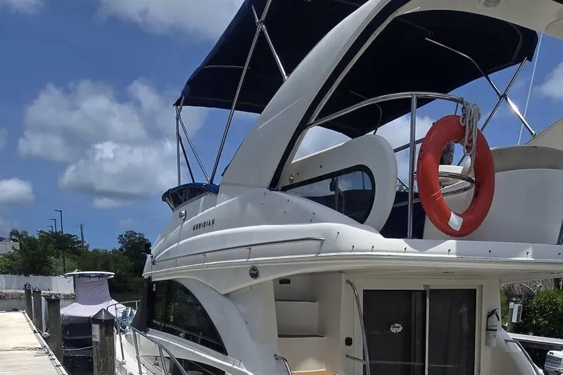  Yacht Photos Pics 2012 Meridian 341 Sedan yacht docked under a clear blue sky.