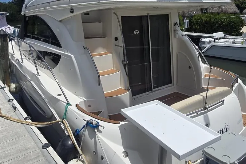  Yacht Photos Pics 2012 Meridian 341 Sedan yacht docked, featuring sleek design and outdoor seating area.