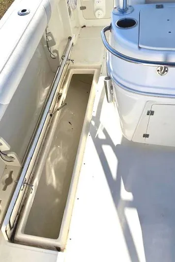  Yacht Photos Pics 2016 Boston Whaler 320 Outrage Cuddy Cabin interior with storage compartment.