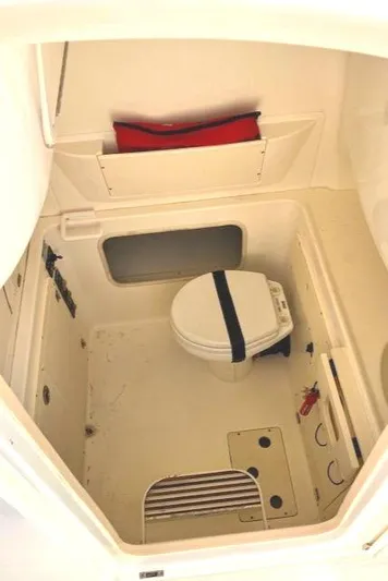  Yacht Photos Pics 2016 Boston Whaler 320 Outrage Cuddy Cabin interior with compact marine toilet.