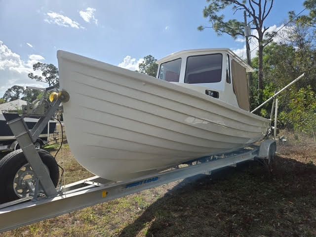 2021 Custom Porter Lobster Boat on trailer outdoors.