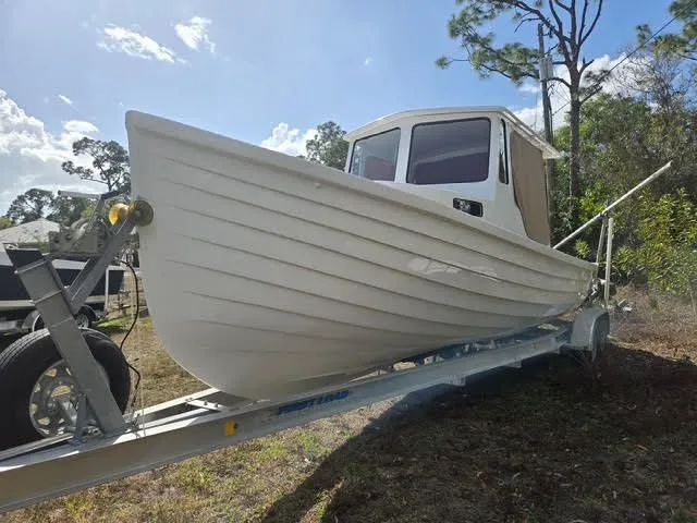 2021 Custom Porter Lobster Boat on trailer outdoors.