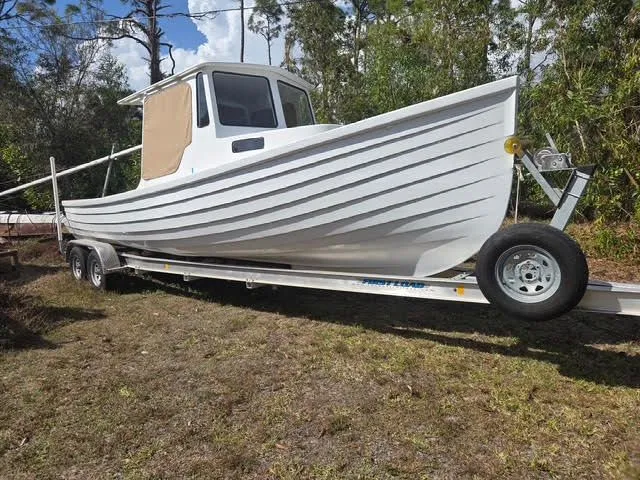 White 2021 Porter Lobster Boat on trailer parked outdoors.