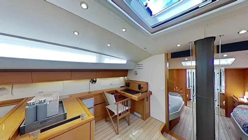 Bodhisattva Yacht Photos Pics Luxurious interior of a 2018 Jeanneau 64 yacht with modern furnishings and skylight.