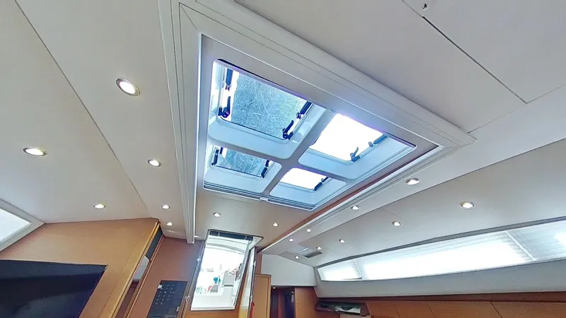 Bodhisattva Yacht Photos Pics Interior view of 2018 Jeanneau 64 yacht with skylight and recessed lighting.