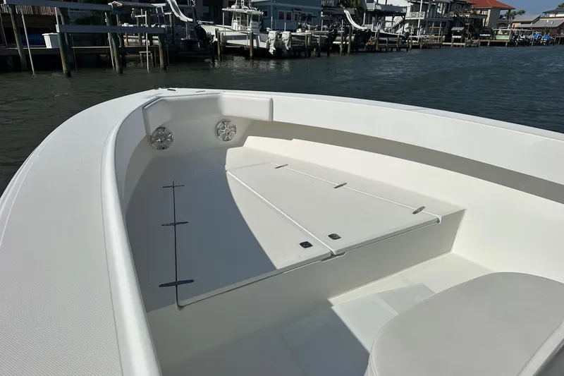  Yacht Photos Pics 2003 Venture 34 Center Console boat interior with seating and storage, docked by waterfront homes.