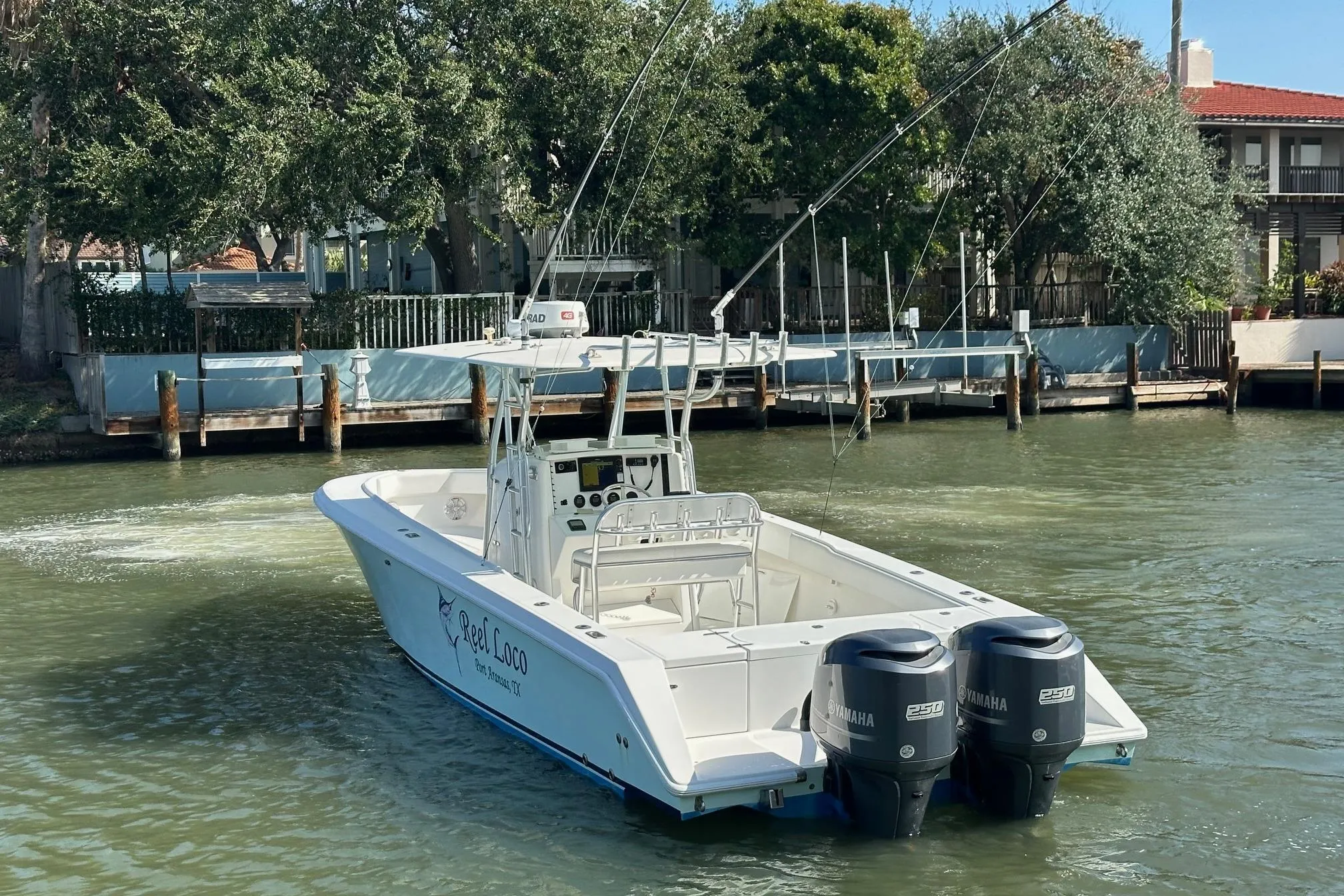 2003 Venture 34 Center Console boat with dual Yamaha engines on a calm waterway.