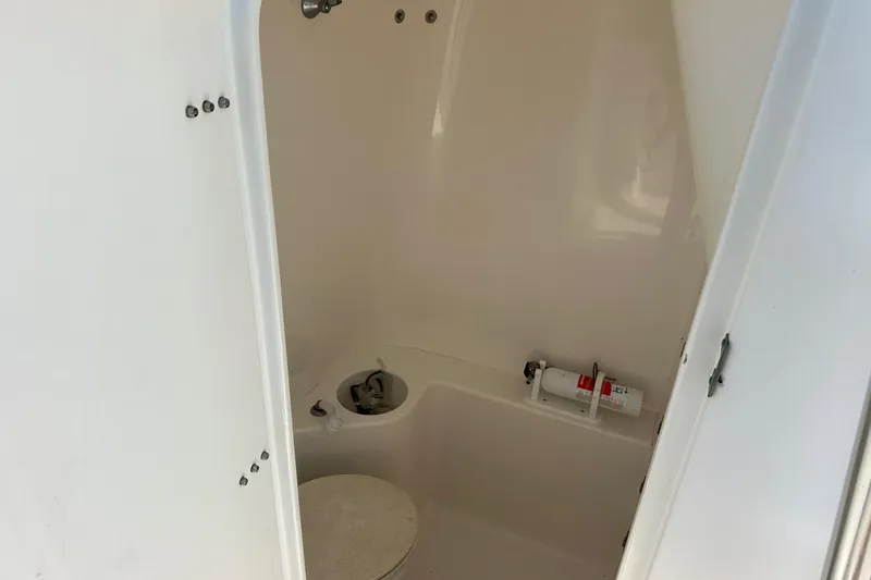  Yacht Photos Pics 2003 Venture 34 Center Console boat interior with toilet and fire extinguisher.