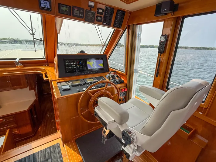 Bira Yacht Photos Pics Helm of 2006 Grand Banks 49 Eastbay SX yacht with navigation equipment and captain's chair.