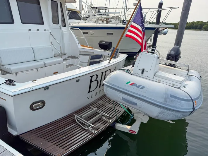 Bira Yacht Photos Pics 2006 Grand Banks 49 Eastbay SX yacht with dinghy and American flag at dock.
