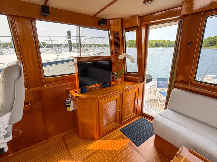 Bira Yacht Photos Pics Luxurious 2006 Grand Banks 49 Eastbay SX yacht interior with wood finish and scenic water view.