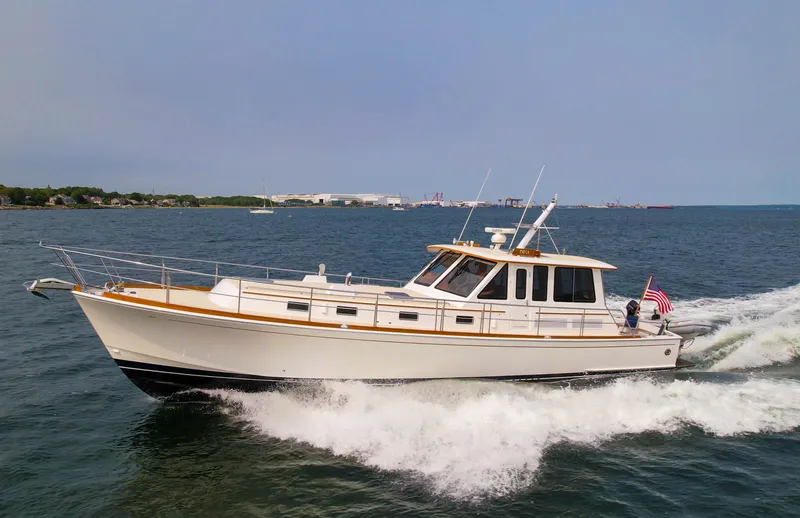 Bira Yacht Photos Pics 2006 Grand Banks 49 Eastbay SX cruising on open water, displaying sleek design and elegance.