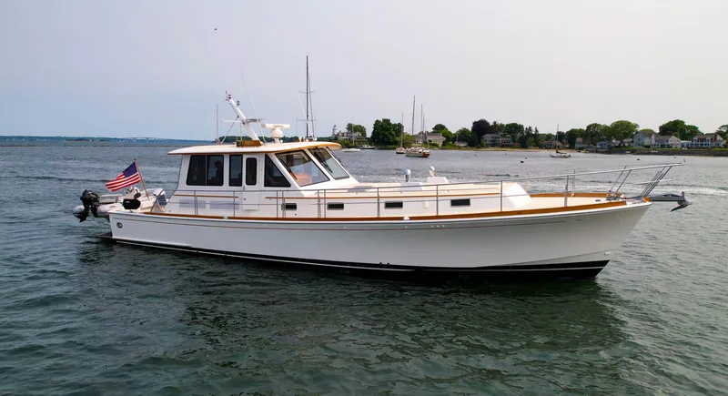 Bira Yacht Photos Pics 2006 Grand Banks 49 Eastbay SX yacht on calm water with American flag.