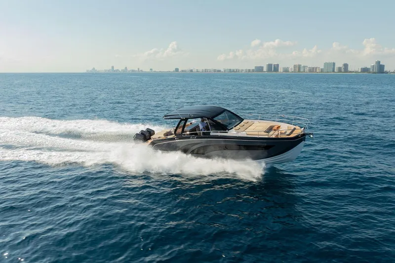  Yacht Photos Pics 2026 Hanover 447 boat cruising on open water with city skyline in background.