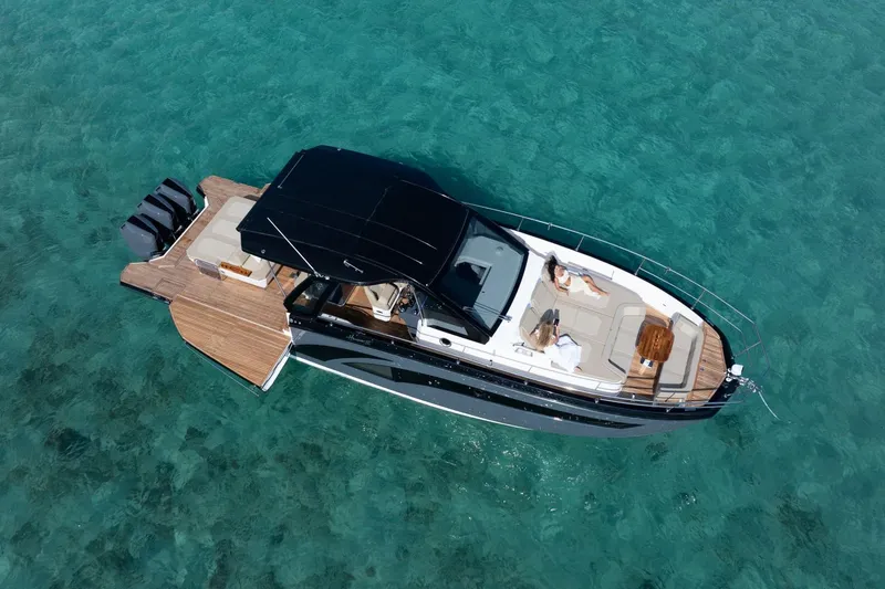  Yacht Photos Pics Aerial view of 2026 Hanover 447 luxury yacht on clear turquoise water.