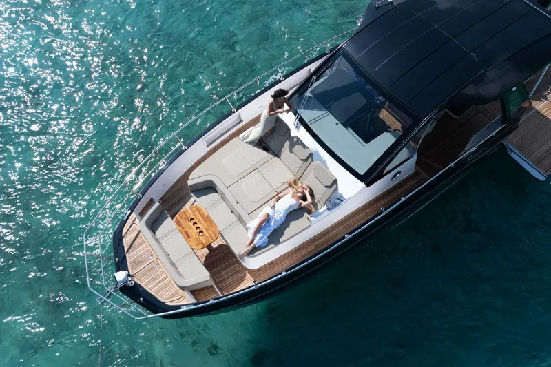  Yacht Photos Pics Aerial view of Hanover 447 yacht, 2026 model, with people relaxing on deck in clear blue water.