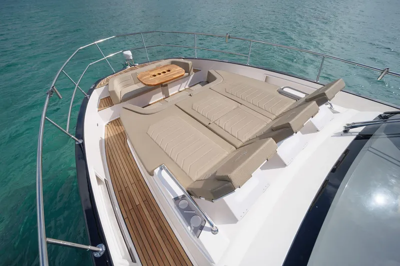  Yacht Photos Pics Luxurious Hanover 447 yacht deck with sun loungers and table, 2026 model, on clear blue water.